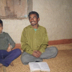Minister in Wojethar village Church reads the Bible to his congregation