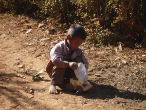 Contented child w homemade bottle truck